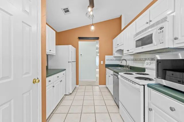 a kitchen with stainless steel appliances granite countertop a stove and a refrigerator