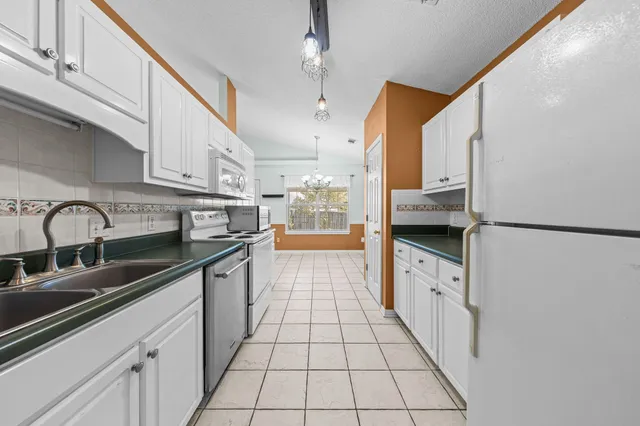 a kitchen with stainless steel appliances granite countertop a sink and cabinets