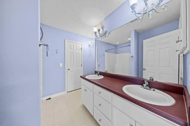 a bathroom with a sink double vanity granite tub and shower