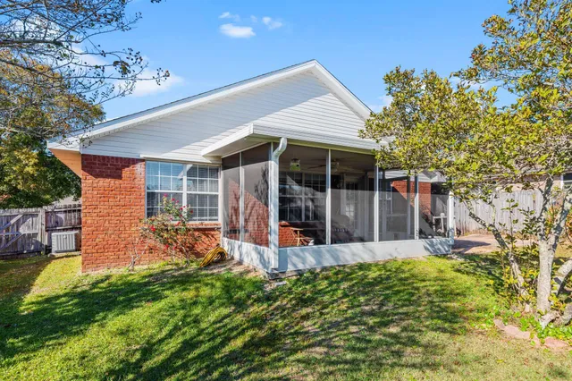 a view of a hallway with wooden floor and chandelier