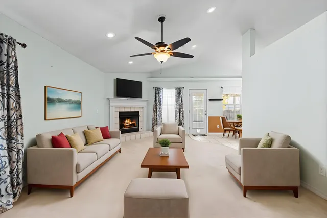 a living room with furniture flat screen tv and a fireplace