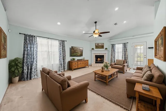 a living room with furniture flat screen tv and a fireplace