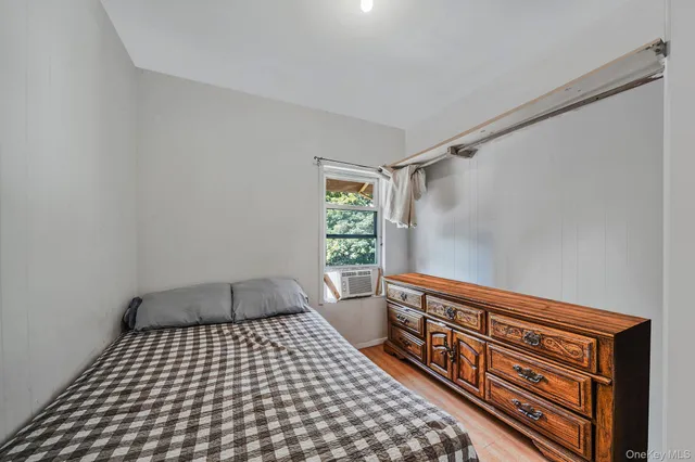 a bedroom with a bed and window