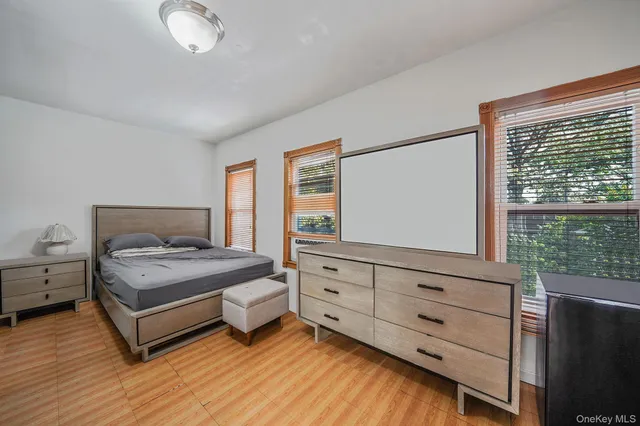 a bedroom with a bed and window