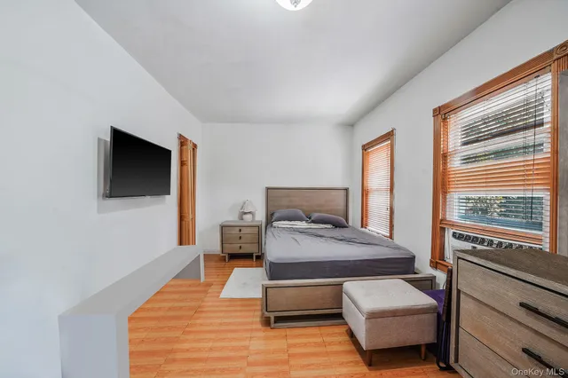 a bedroom with furniture and a flat screen tv