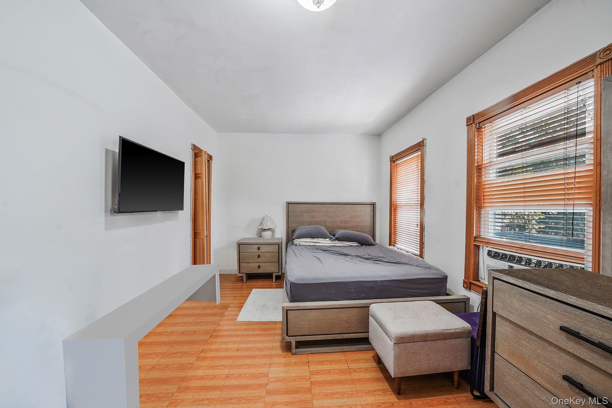 91-26 110th Street Queens, NY 11418 - Photo 16 of 25 a bedroom with furniture and a flat screen tv