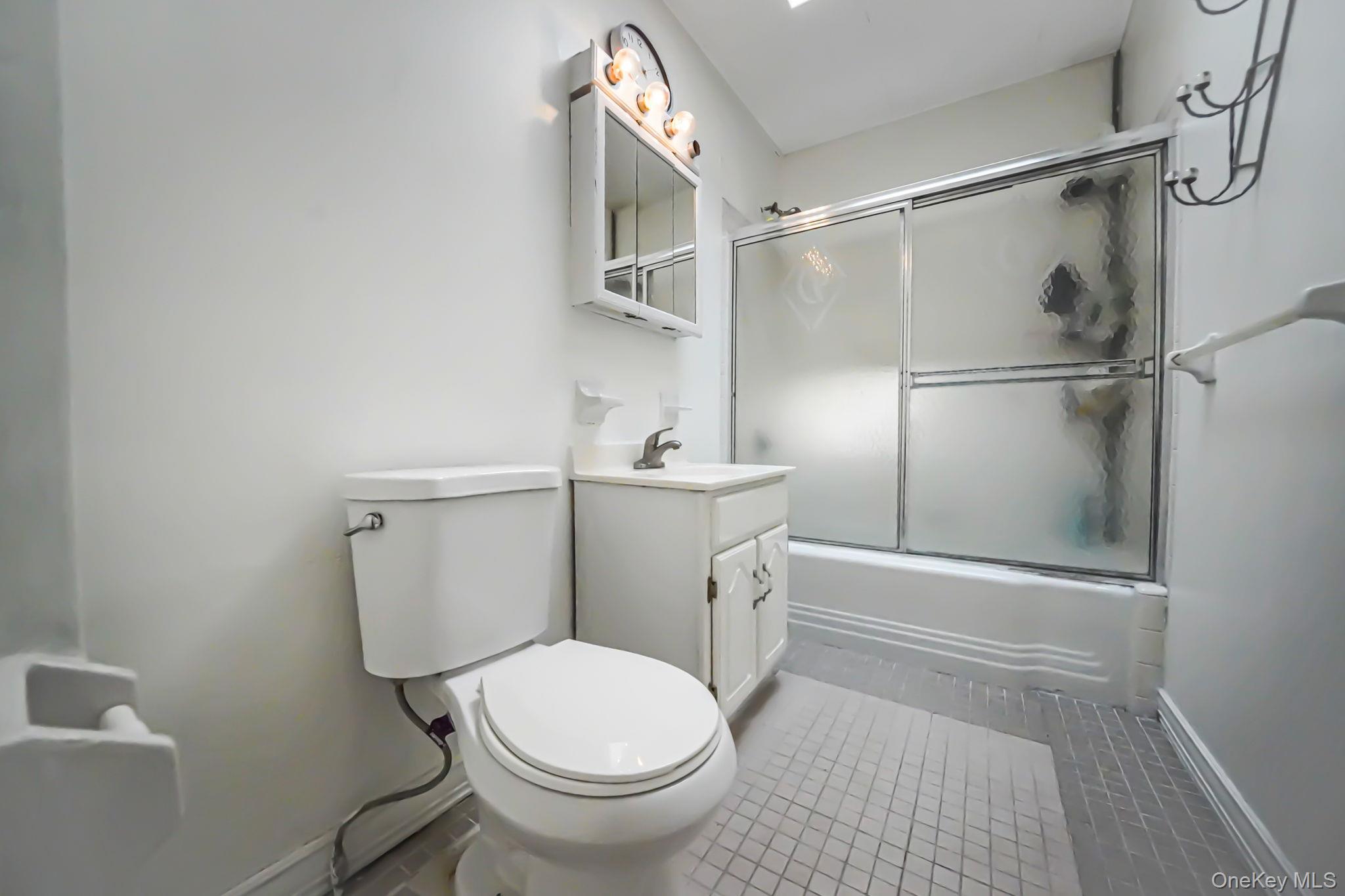 91-26 110th Street Queens, NY 11418 - Photo 17 of 25 a bathroom with a sink a toilet and shower
