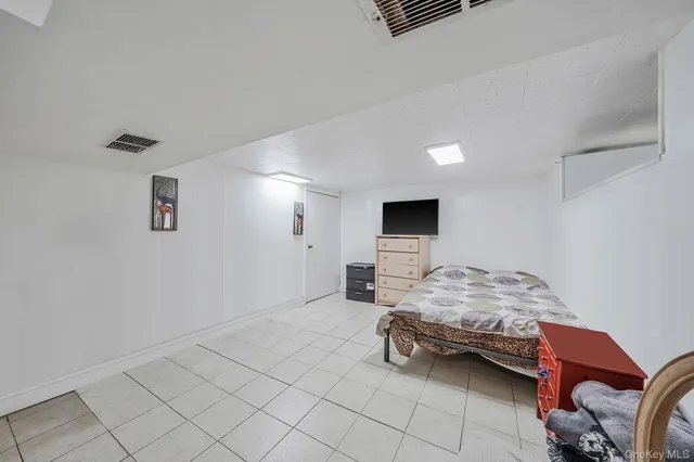 a bedroom with a bed and a couch