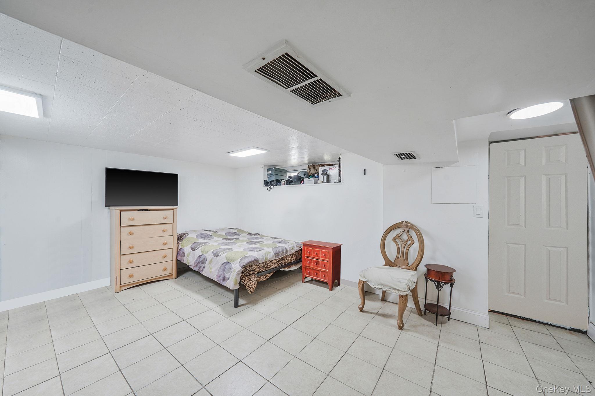 91-26 110th Street Queens, NY 11418 - Photo 20 of 25 a living room with furniture and a flat screen tv