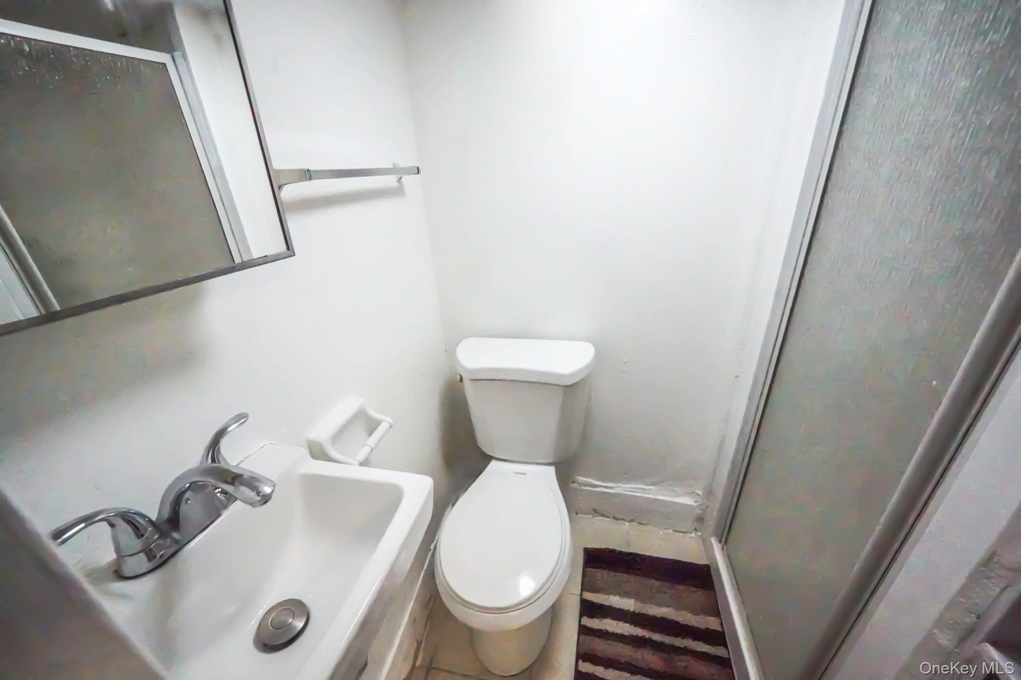 91-26 110th Street Queens, NY 11418 - Photo 22 of 25 a bathroom with a toilet and a sink
