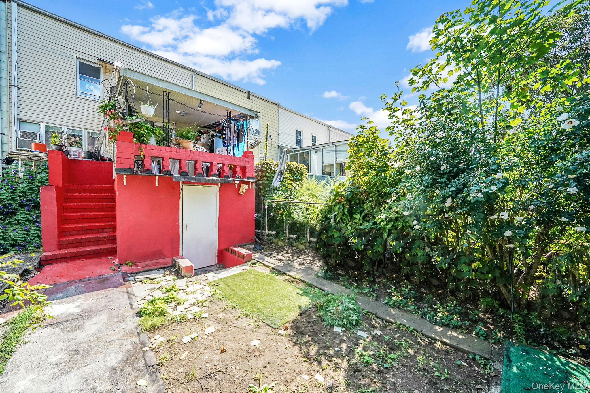91-26 110th Street Queens, NY 11418 - Photo 24 of 25 a front view of a house with garden