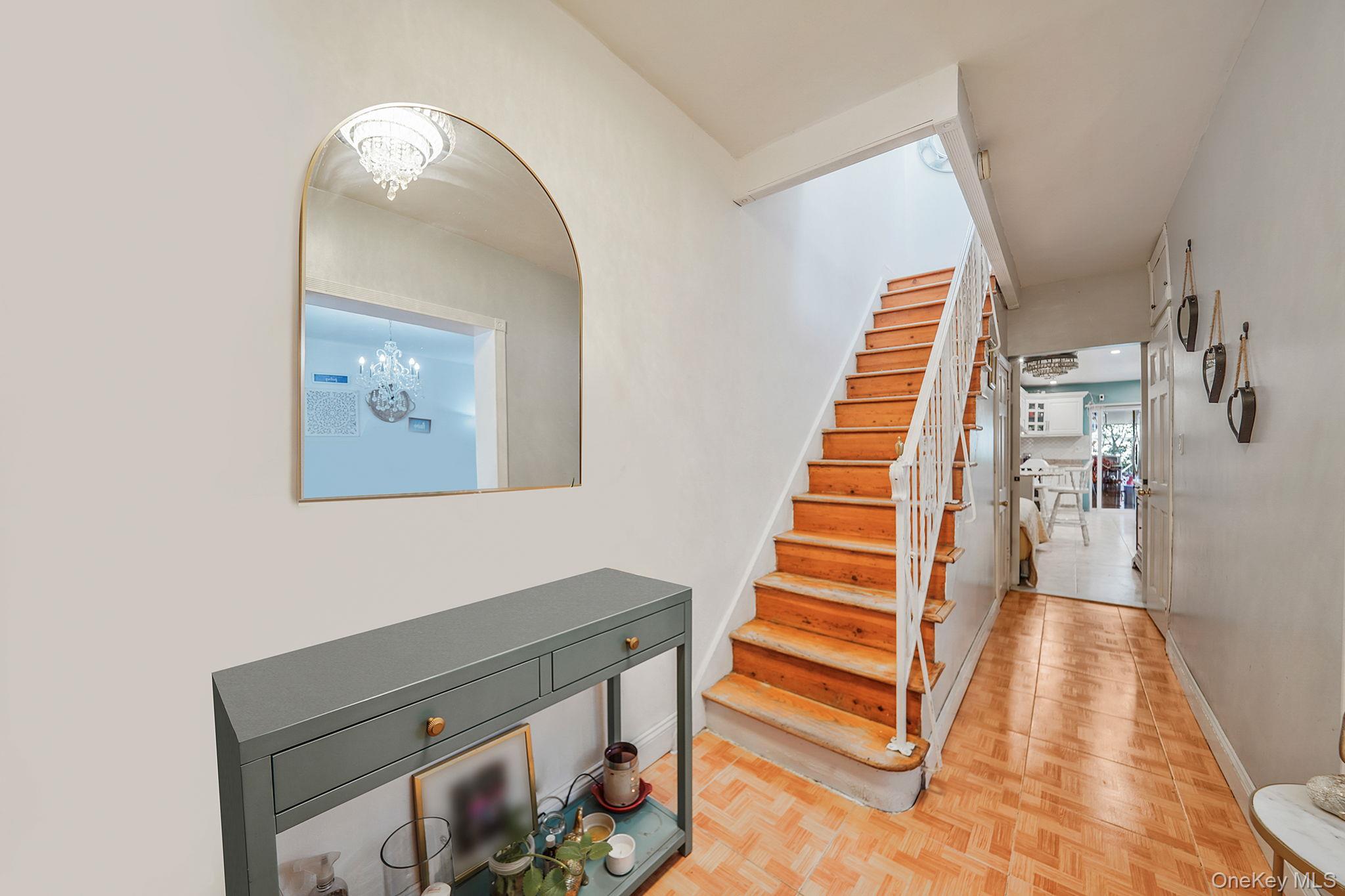 91-26 110th Street Queens, NY 11418 - Photo 3 of 25 a view of a livingroom with wooden floor and stairs