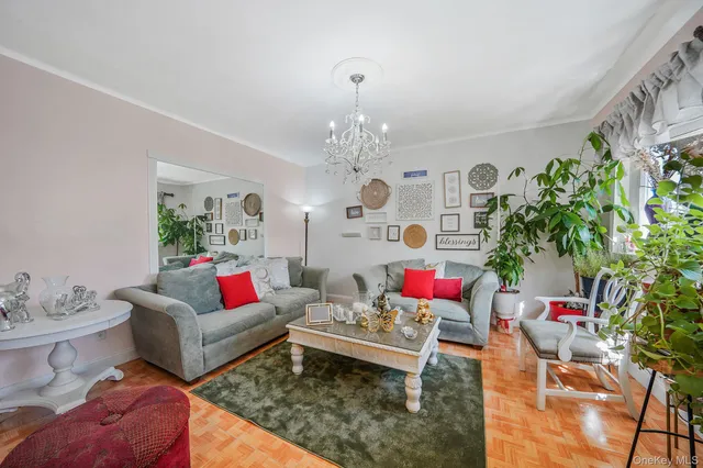 a living room with furniture and a chandelier
