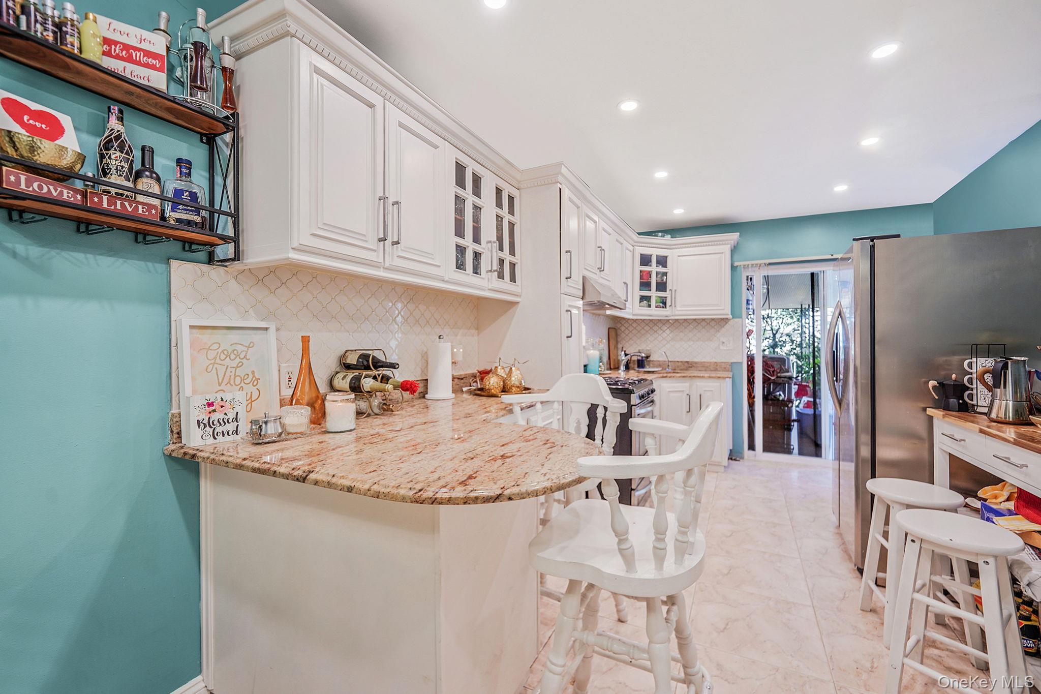 91-26 110th Street Queens, NY 11418 - Photo 7 of 25 a view of a kitchen with stainless steel appliances granite countertop a sink and cabinets