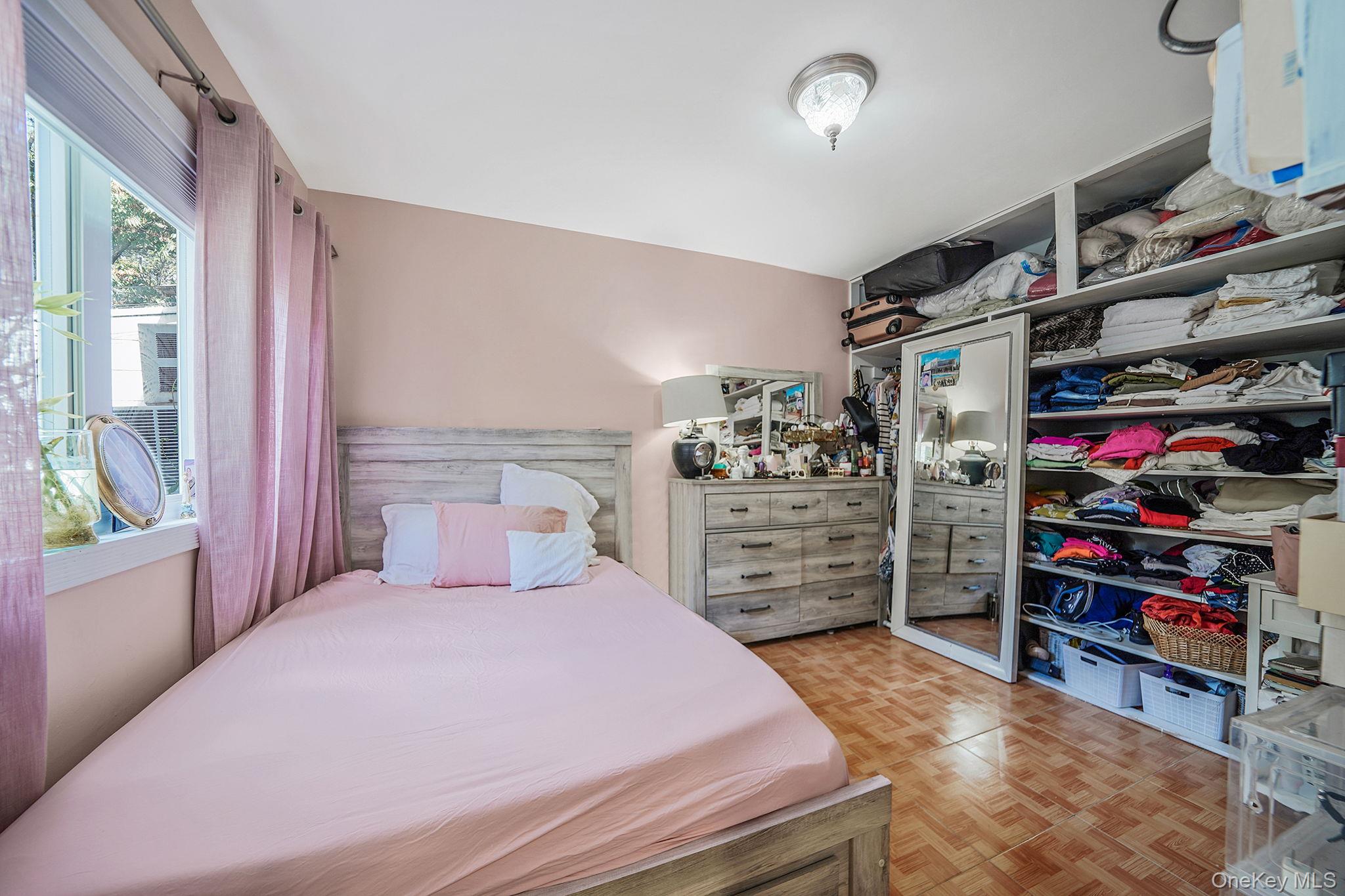 91-26 110th Street Queens, NY 11418 - Photo 10 of 25 a bedroom with a bed and a walk in closet