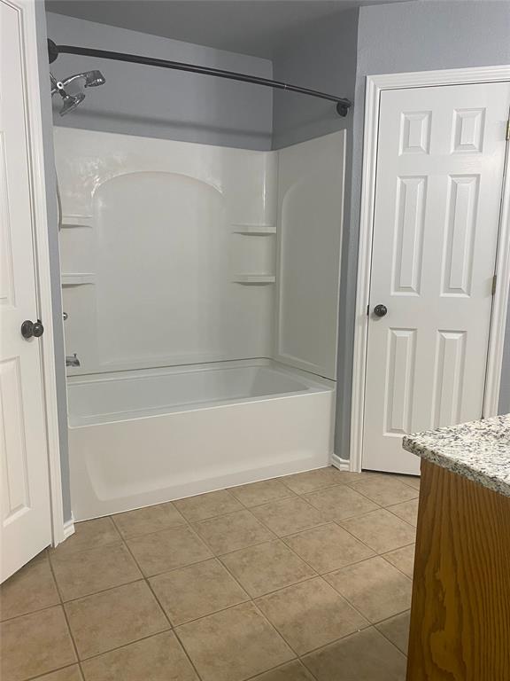 150 Hunters Circle Weatherford, TX 76088 - Photo 20 of 25 a bathroom with a bathtub and a shower