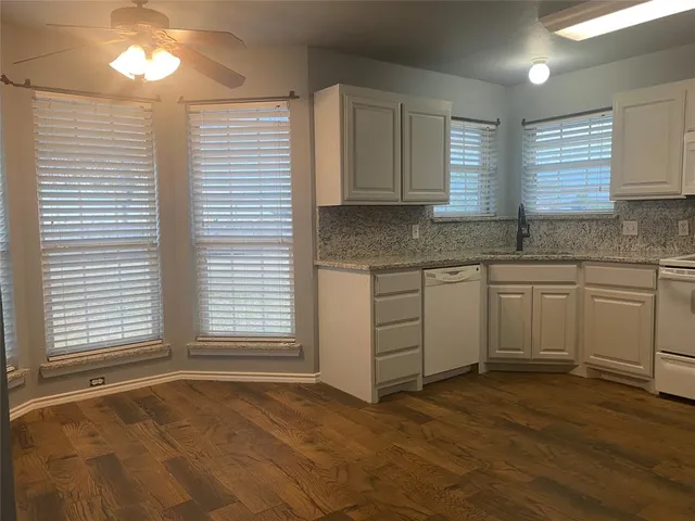 a view of a kitchen with a sink cabinets and a window