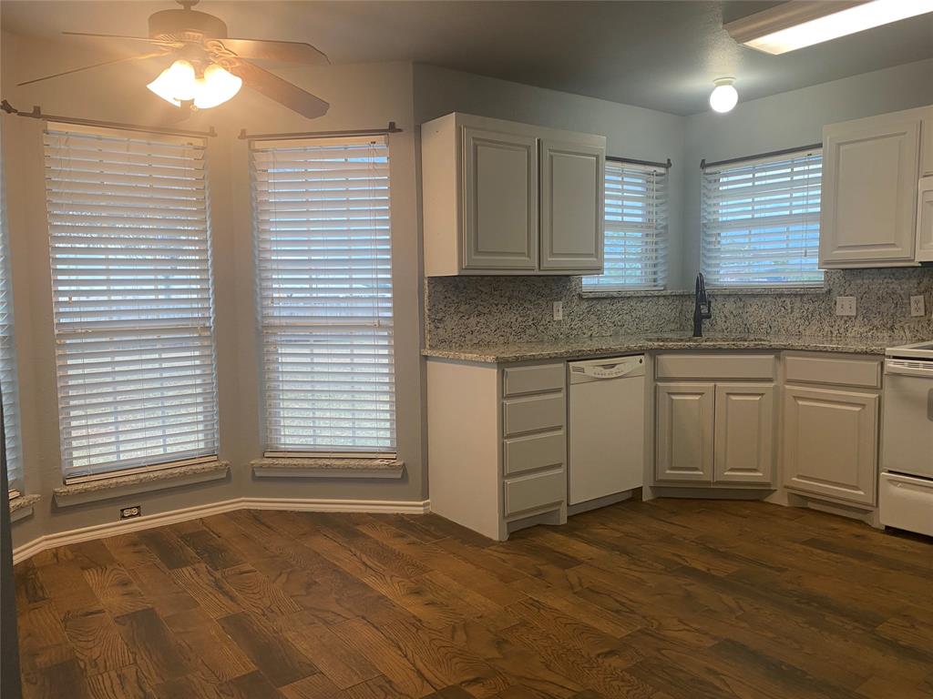 150 Hunters Circle Weatherford, TX 76088 - Photo 6 of 25 a view of a kitchen with a sink cabinets and a window