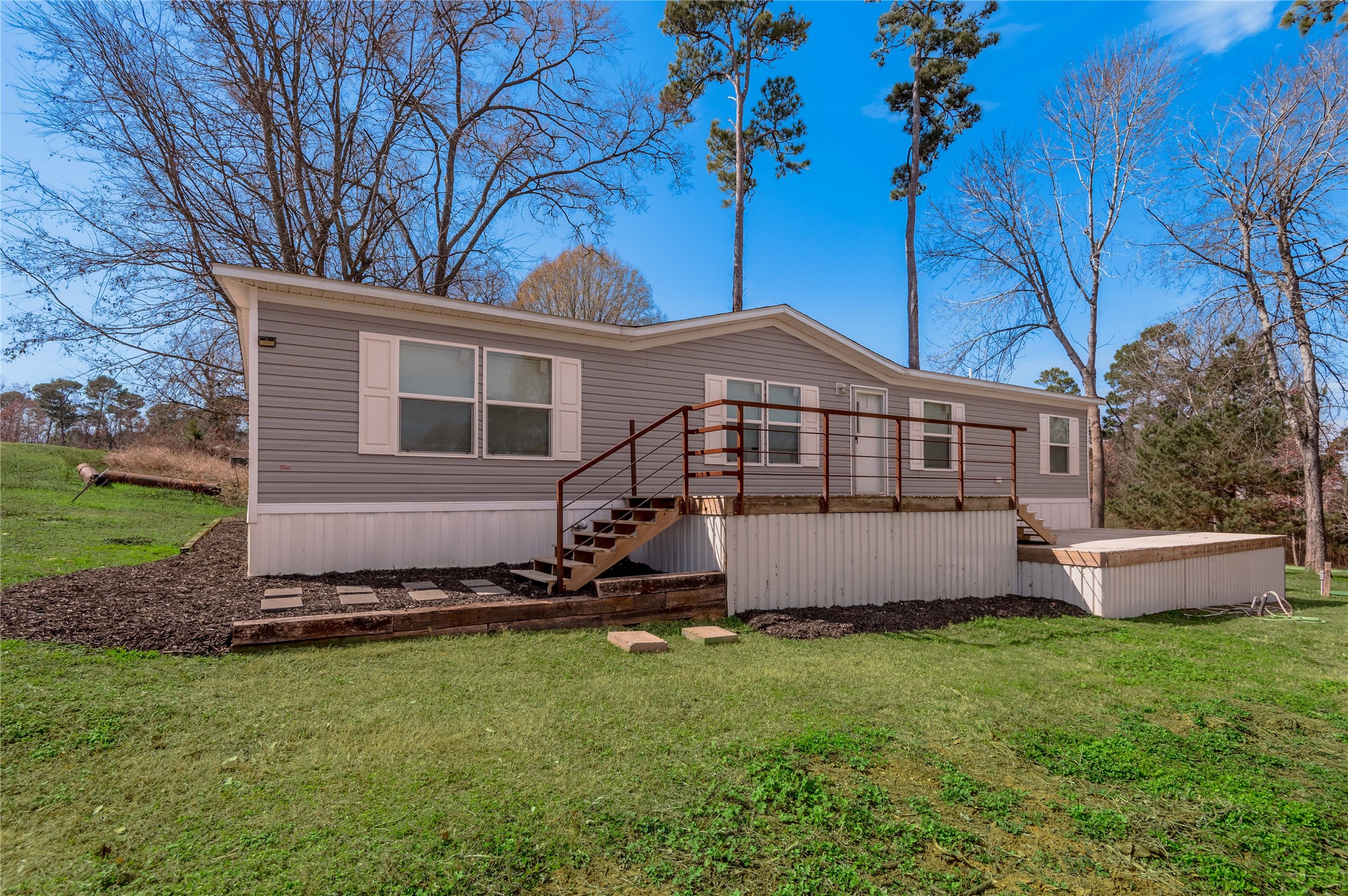 531 Canal Drive Point Blank, TX 77364 - Photo 1 of 49 Front view of this beautiful home. You can sit out on your deck and take in the water view.