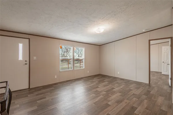 a kitchen with a stove a sink a microwave and wooden cabinets