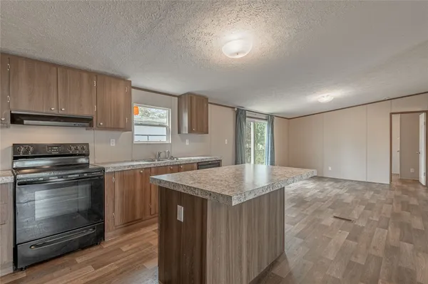 a view of a kitchen counter space and wooden floor