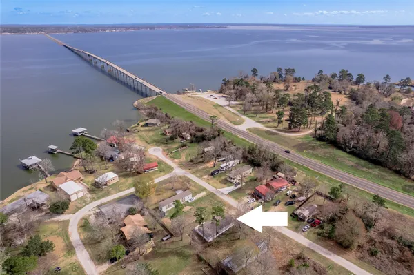 a front view of a house with a garden and yard