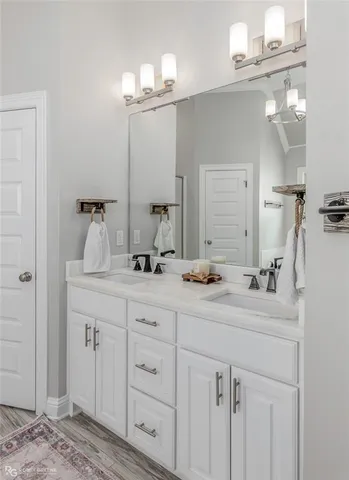 a bathroom with a double vanity sink and a mirror