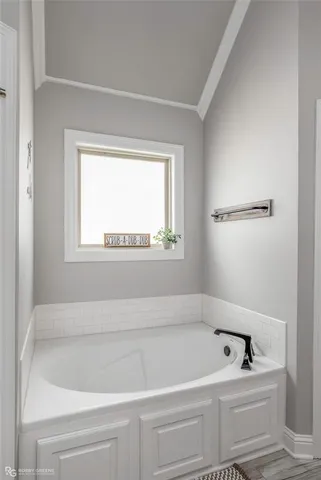 a bathroom with a bathtub and window
