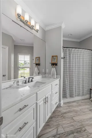 a spacious bathroom with double sink and a mirror