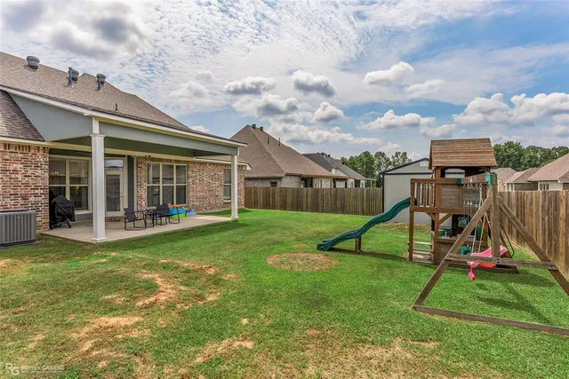 a view of a house with a yard and sitting area