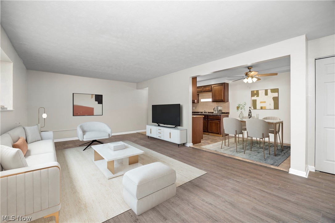 5382 Lee Road, Unit 102 Maple Heights, OH 44137 - Photo 6 of 25 Living area with ceiling fan and light wood-style floors