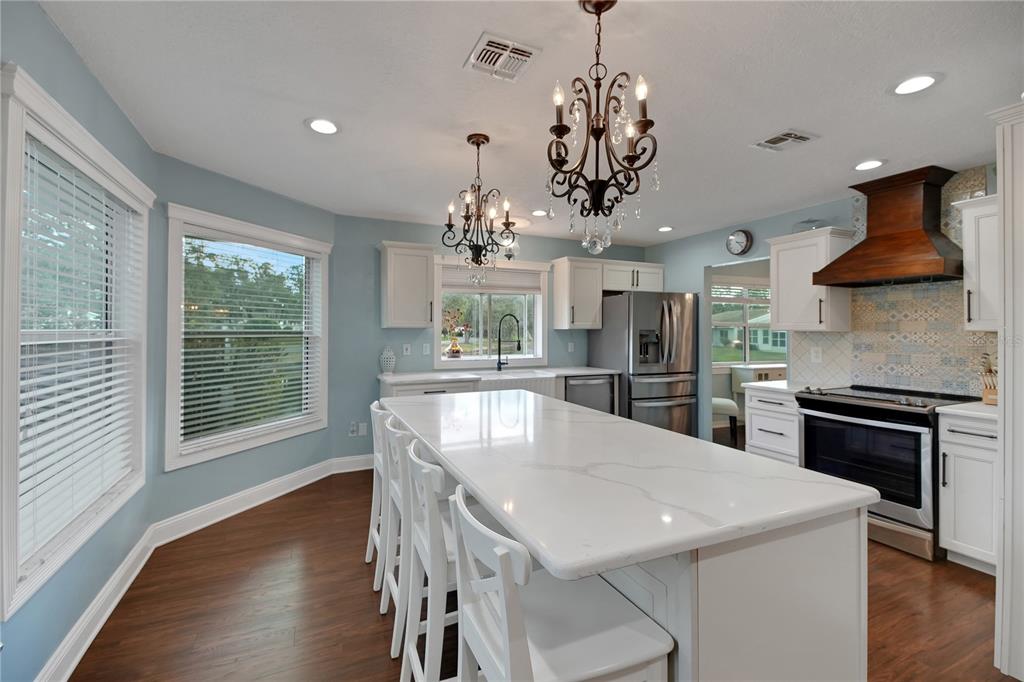 32801 Oak Park Drive Leesburg, FL 34748 - Photo 15 of 46 a view of a dining room with furniture window and wooden floor