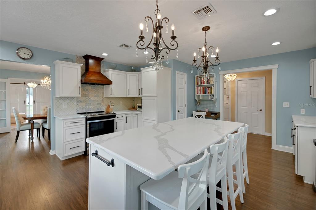 32801 Oak Park Drive Leesburg, FL 34748 - Photo 17 of 46 a view of a dining room with furniture and wooden floor