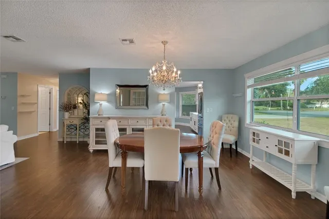 a view of a hallway with wooden floor windows and a livingroom