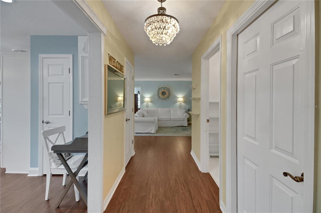 32801 Oak Park Drive Leesburg, FL 34748 - Photo 19 of 46 a view of a hallway with wooden floor windows and a livingroom
