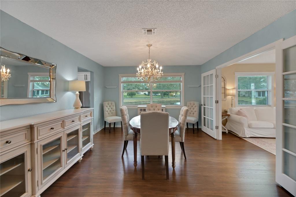 32801 Oak Park Drive Leesburg, FL 34748 - Photo 20 of 46 a view of a dining room with furniture window and wooden floor
