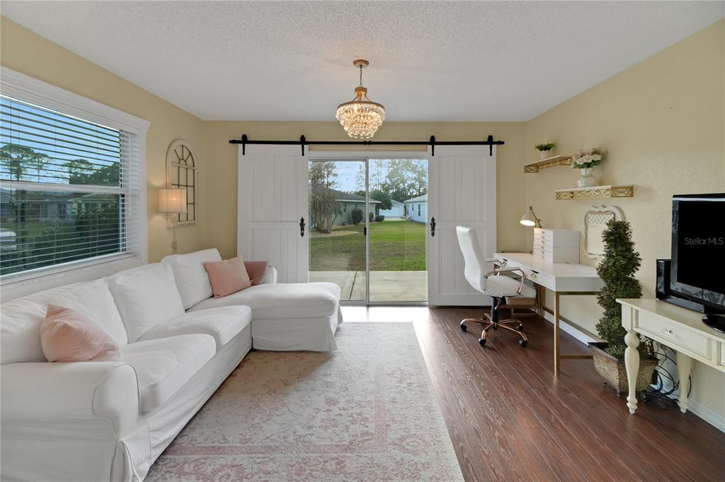 32801 Oak Park Drive Leesburg, FL 34748 - Photo 21 of 46 a living room with furniture a window and a flat screen tv