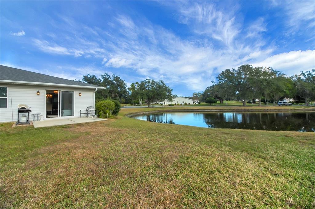 32801 Oak Park Drive Leesburg, FL 34748 - Photo 22 of 46 a view of a house with a yard and a large tree