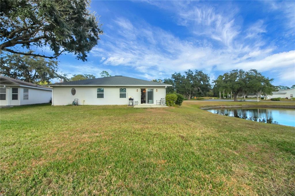 32801 Oak Park Drive Leesburg, FL 34748 - Photo 24 of 46 a front view of a house with a garden and lake view