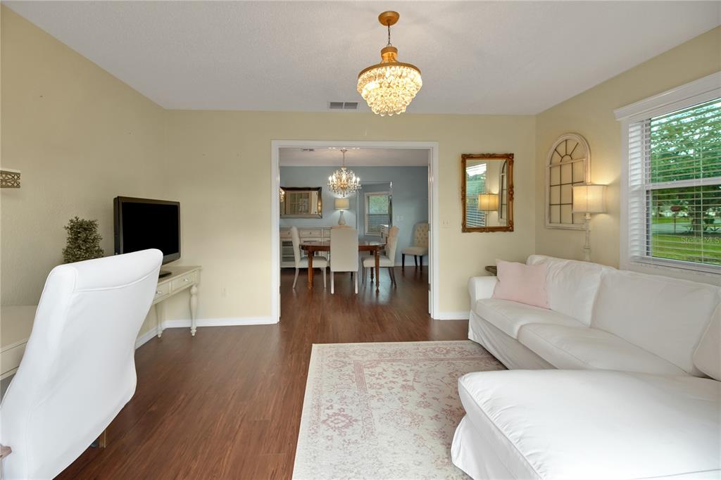 32801 Oak Park Drive Leesburg, FL 34748 - Photo 26 of 46 a living room with furniture and a large window
