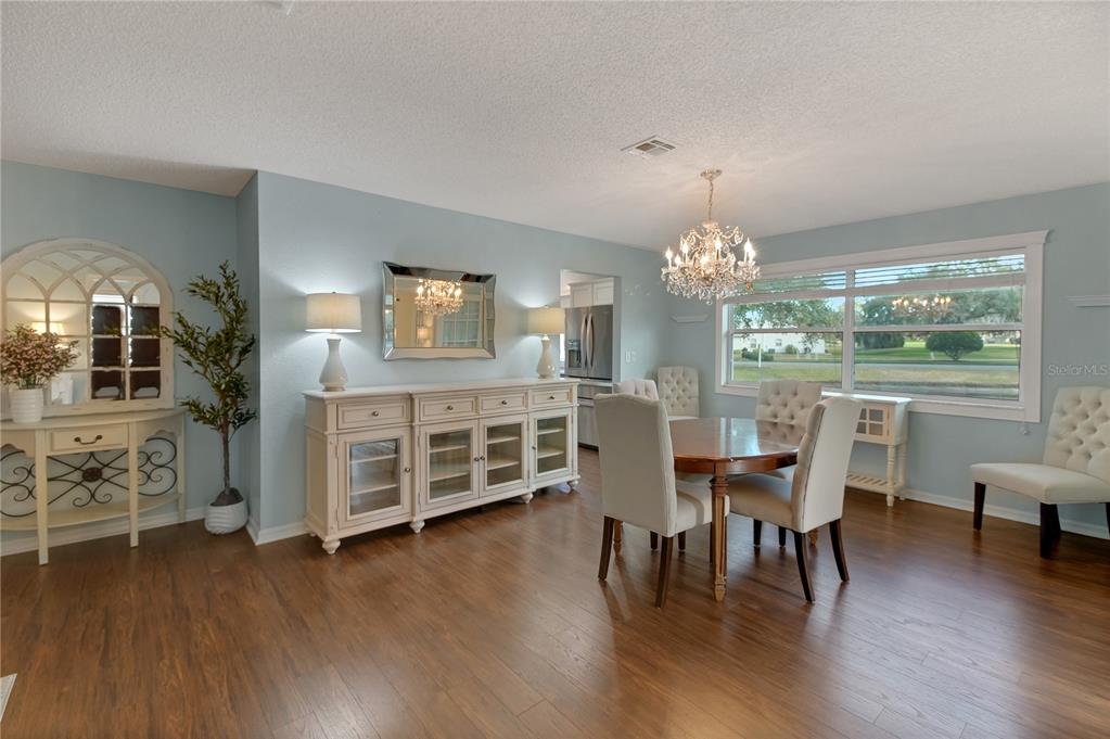 32801 Oak Park Drive Leesburg, FL 34748 - Photo 27 of 46 a view of a dining room with furniture window and wooden floor