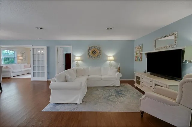 a bedroom with a bed and dresser with mirror