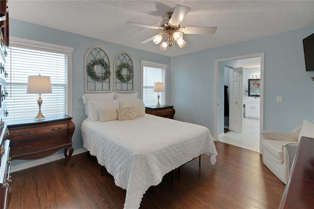 32801 Oak Park Drive Leesburg, FL 34748 - Photo 32 of 46 a bedroom with a bed mirror and a window