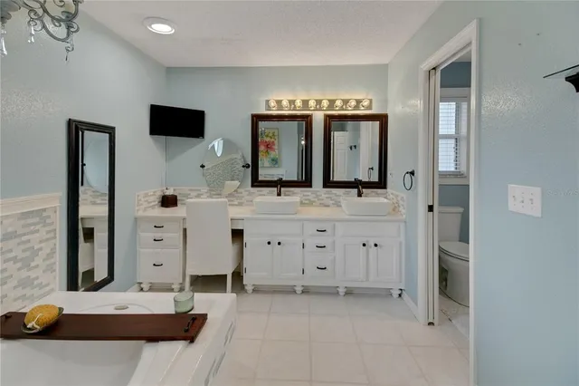 a bathroom with a glass shower door and a mirror