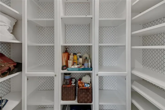 a view of walk in closet with clothes