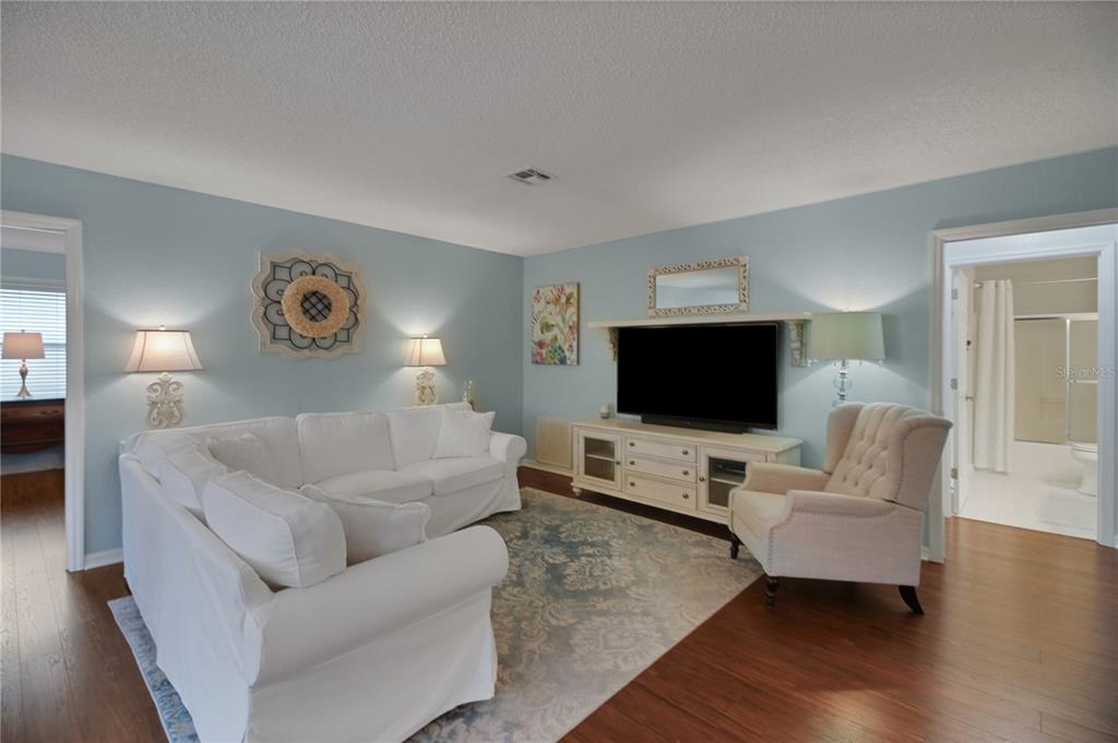 32801 Oak Park Drive Leesburg, FL 34748 - Photo 39 of 46 a living room with furniture and a flat screen tv