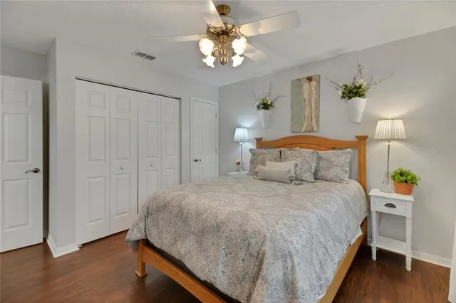 a spacious bedroom with a bed and a chandelier
