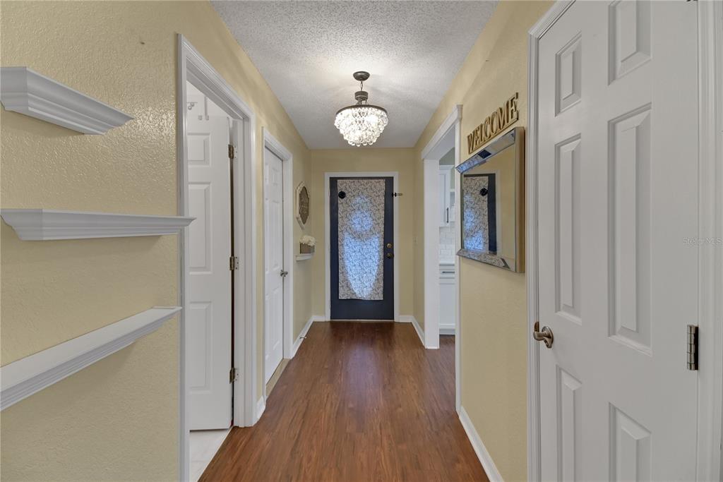 32801 Oak Park Drive Leesburg, FL 34748 - Photo 7 of 46 a view of a hallway with wooden floor