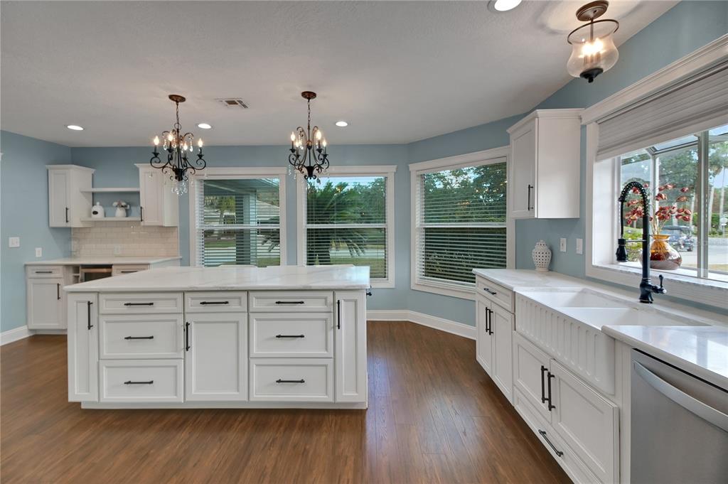32801 Oak Park Drive Leesburg, FL 34748 - Photo 10 of 46 a spacious bathroom with a granite countertop sink a large mirror and a next to a window