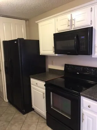 a kitchen with a sink stove and microwave